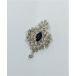 A massive sapphire and diamond drop pendant set in