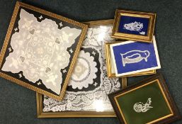 A box containing framed and glazed Honiton lace pa
