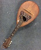 An olive wood mounted oud with inlay decoration. E