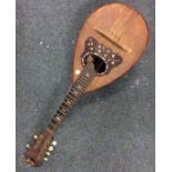 An olive wood mounted oud with inlay decoration. E