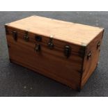 A hinged top camphor wood trunk mounted with carry