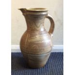 MIKE CASSON: A tall pottery ewer with textured bod