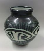 RAY MARSHALL: A green ground pottery vase of balus