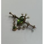 A peridot and pearl brooch in the form of a shield