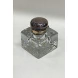 An Edwardian cut glass rectangular inkwell with si