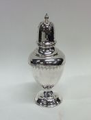 An Edwardian vase shaped silver caster decorated w