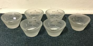 A set of six 'Moet & Chandon' glass candle holders