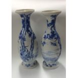 A tall pair of blue and white vases with floral de