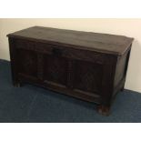 A Georgian oak hinged top coffer with panelled fro
