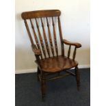 An old slat back kitchen chair with tapering handl