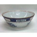 A Chinese bowl decorated with flowers and leaves t