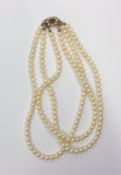 A good triple sting of pearl beads with gold and g