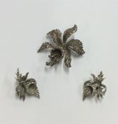 A silver and marcasite brooch in the form of flowe