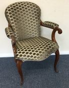 An upholstered armchair with padded arm rest to ca