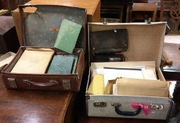 A suitcase containing maps, brass medals and books