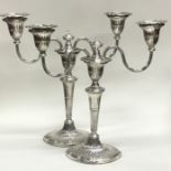 A pair of Georgian style fluted silver candelabra