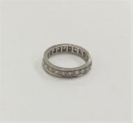 A diamond full eternity ring in carved setting. Fi