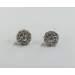 A pair of circular diamond cluster earrings. Appro