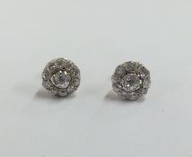 A pair of circular diamond cluster earrings. Appro