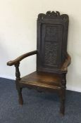 An Antique oak carved hall chair. Est. £40 - £60.