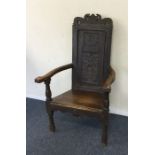 An Antique oak carved hall chair. Est. £40 - £60.