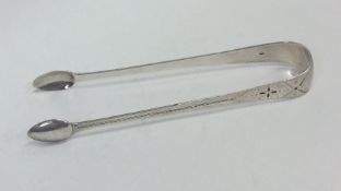 A pair of Georgian silver bright cut sugar tongs.