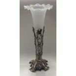 A tall opaque glass trumpet on embossed scroll dec