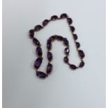 An Antique graduated amethyst necklace with concea