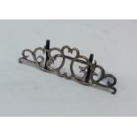 An attractive silver menu holder with scroll decor
