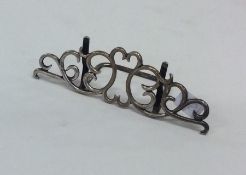 An attractive silver menu holder with scroll decor