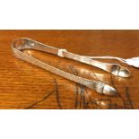 A pair of unusual bright cut silver sugar tongs mo