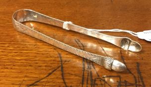 A pair of unusual bright cut silver sugar tongs mo