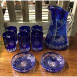 An attractive blue glass lemonade set with flower