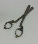 A pair of Continental silver cast scissors decorat