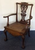 A Georgian mahogany commode chair on ball and claw