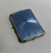 A silver and enamel compact with mirrored interior