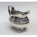 EXETER: A Georgian silver cream jug with reeded bo
