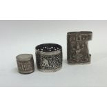 An embossed Indian silver napkin ring together wit