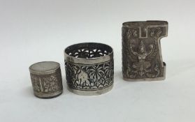 An embossed Indian silver napkin ring together wit