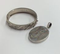 A silver oval locket with loop top together with a