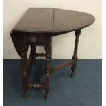 A Georgian mahogany drop leaf table on stretcher b