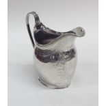 A Georgian silver helmet shaped cream jug with cre