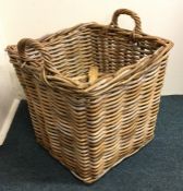 An old wicker two handled log basket. Est. £25 - £