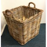 An old wicker two handled log basket. Est. £25 - £