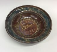 A stylish earthenware shallow bowl in green and br