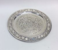 A large circular silver commemorative dish with ba