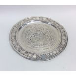 A large circular silver commemorative dish with ba