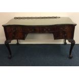 A good quality Chippendale style five drawer desk