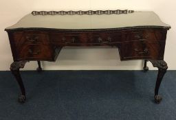 A good quality Chippendale style five drawer desk