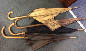 A selection of four Antique umbrellas. Est. £20 -